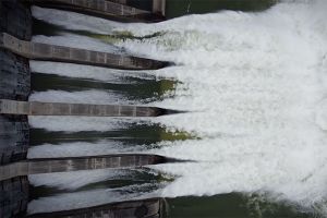 An overhead shot of a generating station's spillway gates.