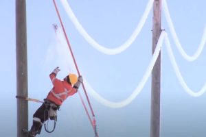 Manitoba Hydro staff de-icing lines.