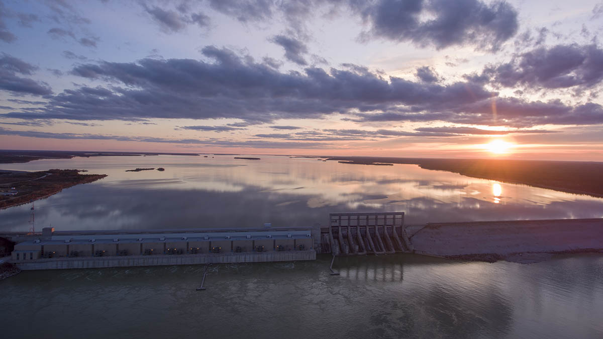 Arial photo of a hydroelectric generating station at sunset.